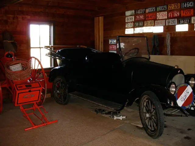 Vintage car and antique fire cart in a barn museum